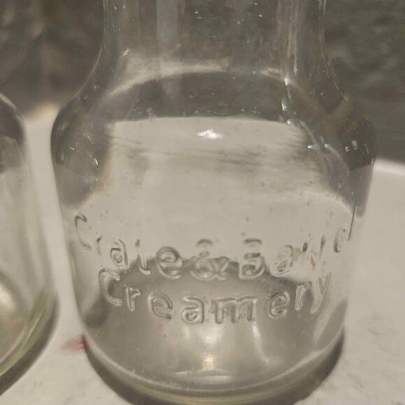 Crate & Barrel Creamery Clear Glass Carafe Jar Lids 2oz 3-1/4" Set of 2 - Picture 2 of 5